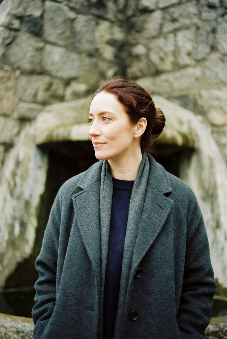 Aoife Ní Mhurchú, guide, smiling in front of the Garden of Remembrance fountain.